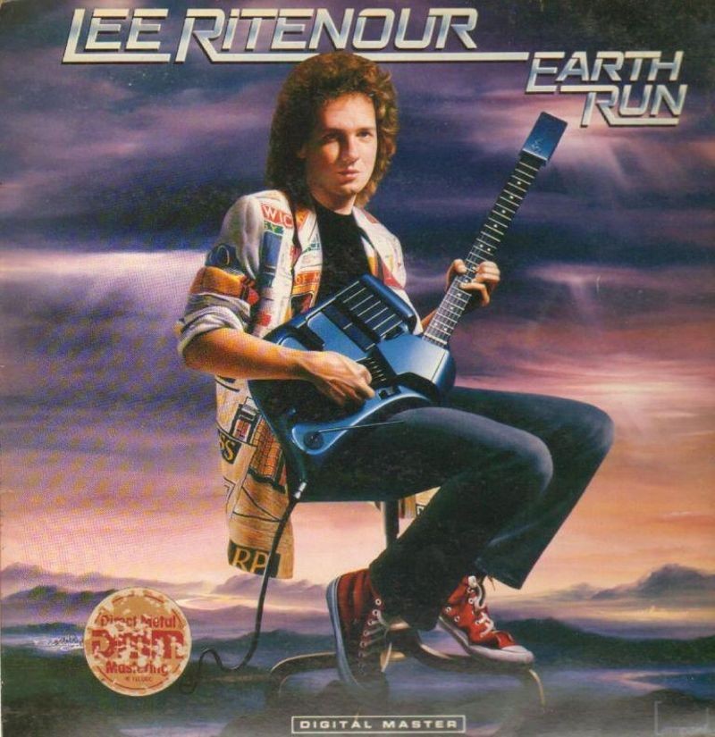 Lee Ritenour holding a SynthAxe on the cover of his album, Earth Run