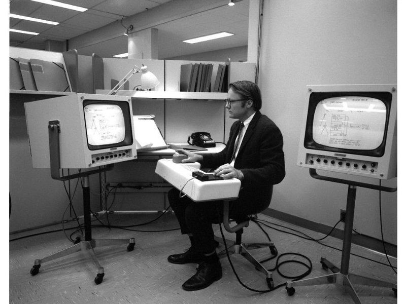 Hardware wizard Bill English with several ergonomic setups for the oNLine System (NLS); late 1960s