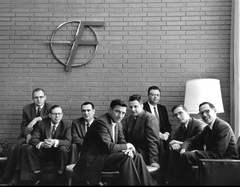The “Traitorous Eight” pose under the “Flying F” logo in the company’s Mountain View lobby. From left: Gordon Moore, Sheldon Roberts, Eugene Kleiner, Robert Noyce, Victor Grinich, Julius Blank, Jean Hoerni, and Jay Last. © Wayne Miller/Magnum Photos.