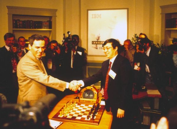 Garry Kasparov shakes hands with Feng-Hsuing Hsu at game 1 of 1997 Deep Blue vs. Kasparov re-match in New York City, New York