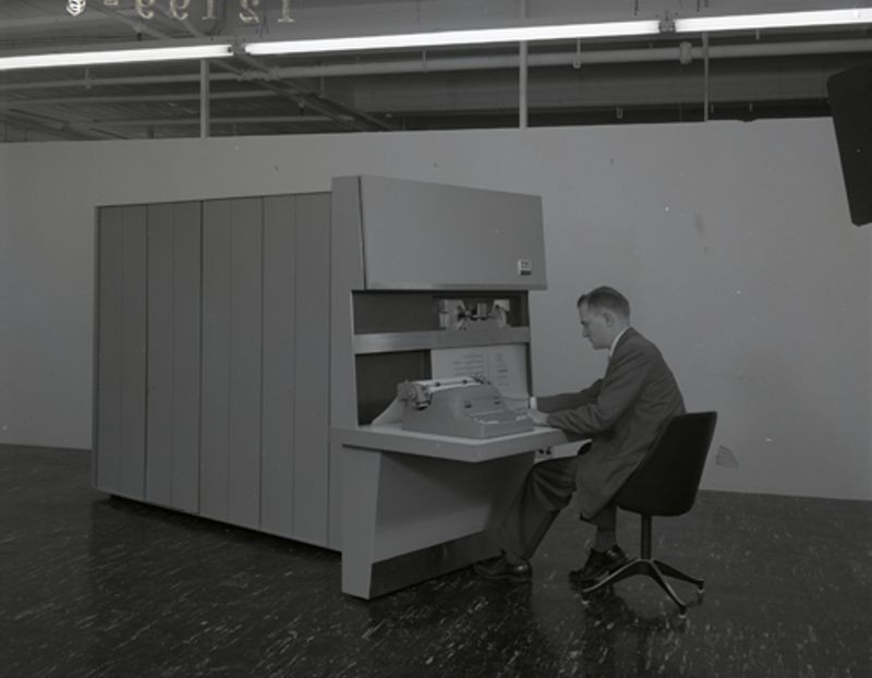 Man at console of an ITT PDP-1 (ADX 7300)