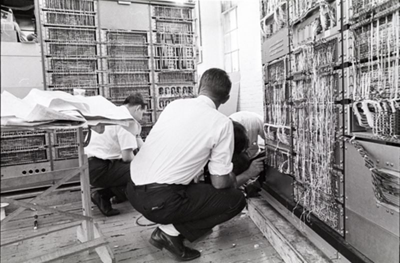 Three men working around PDP-1