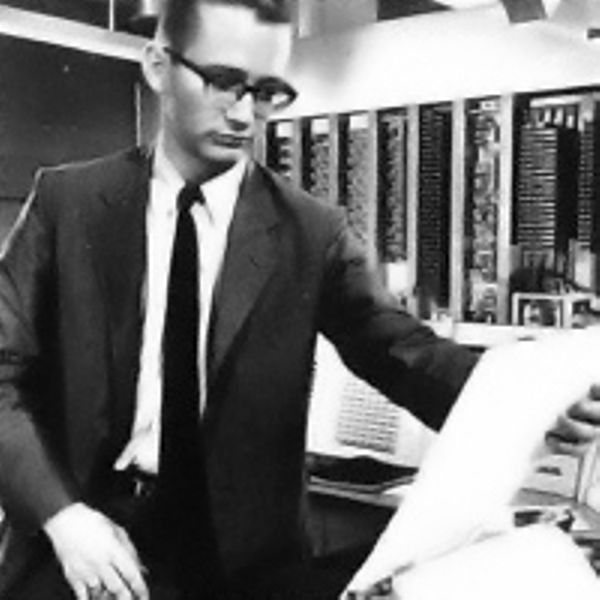 Harrison Dit Morse, one of the programmers, looks at a script being printed on the TX-0