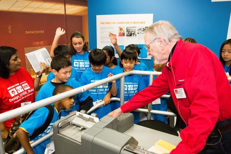 Students get an up-close look at the IBM 1401′s punched card reader with Museum docent Paul Laughton.