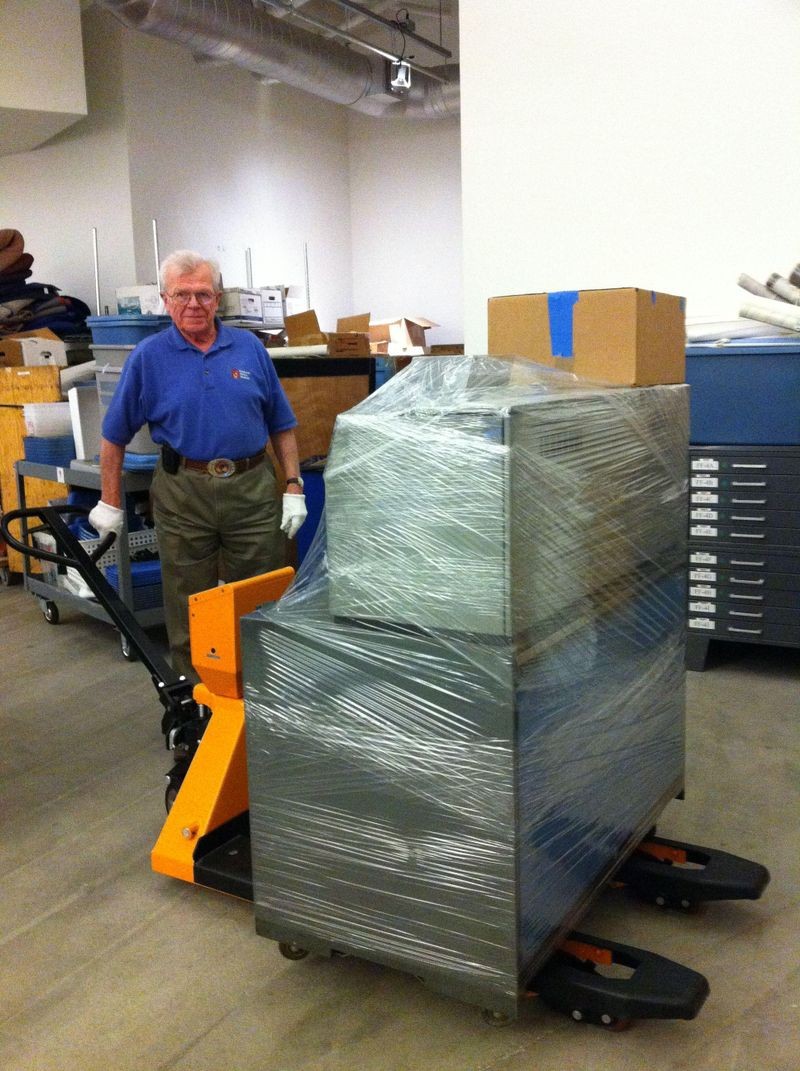 IBM retiree and collections volunteer Dave Bennet test drives the new pallet jack, purchased with funding from an IBM Corporate Citizenship grant.