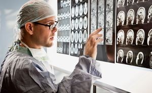 Surgeon examines MRI data sets