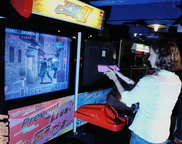 A gamer playing video game Time Crisis II